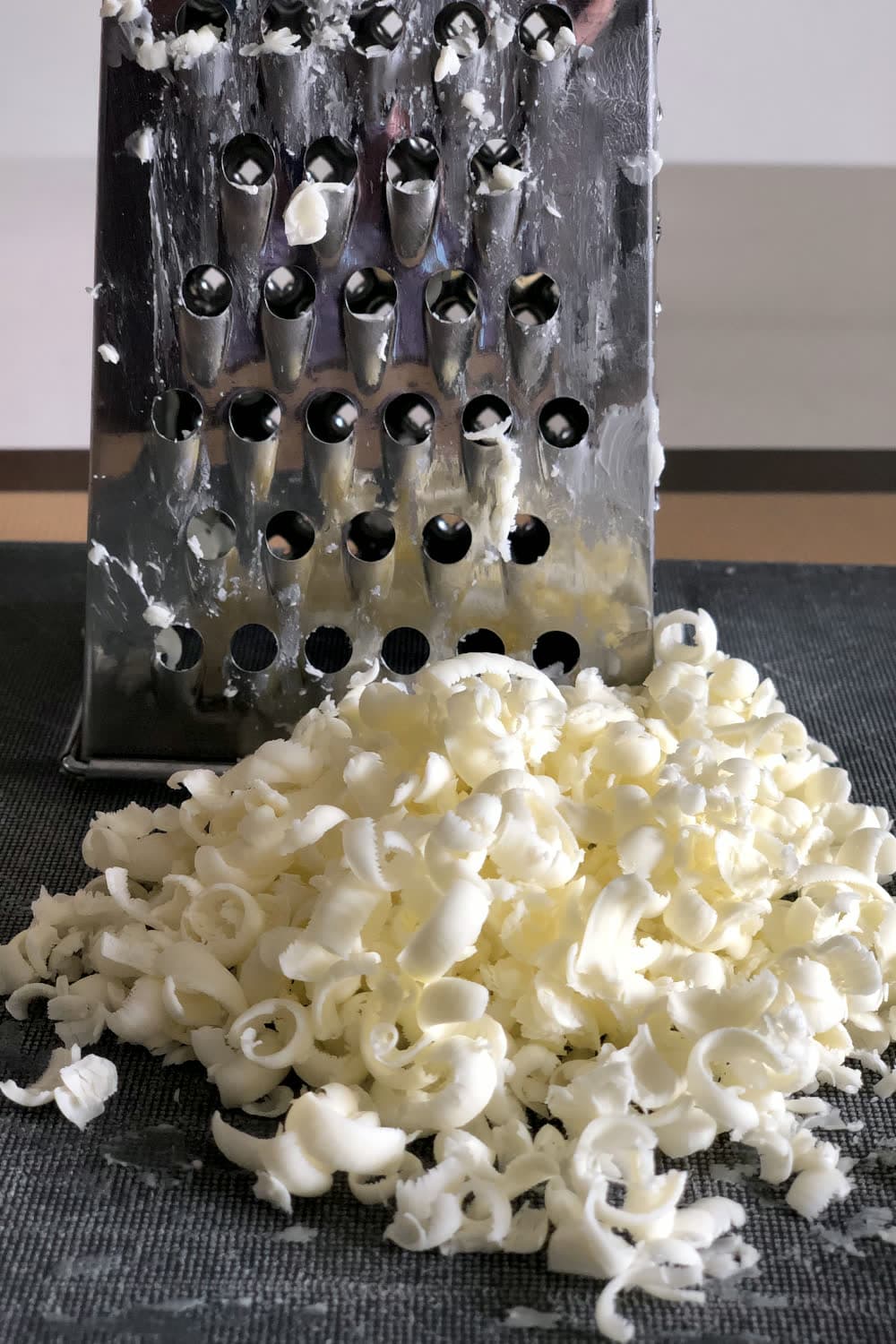 grating cold butter into flour