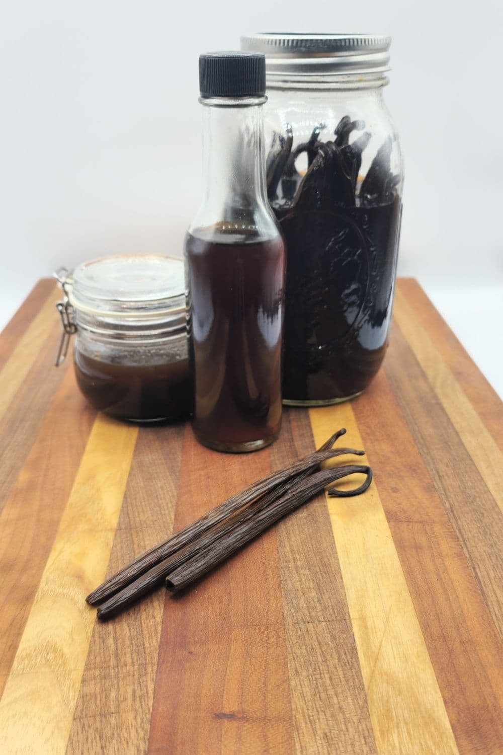 Vanilla beans stored in glass jar, extract in dark bottle