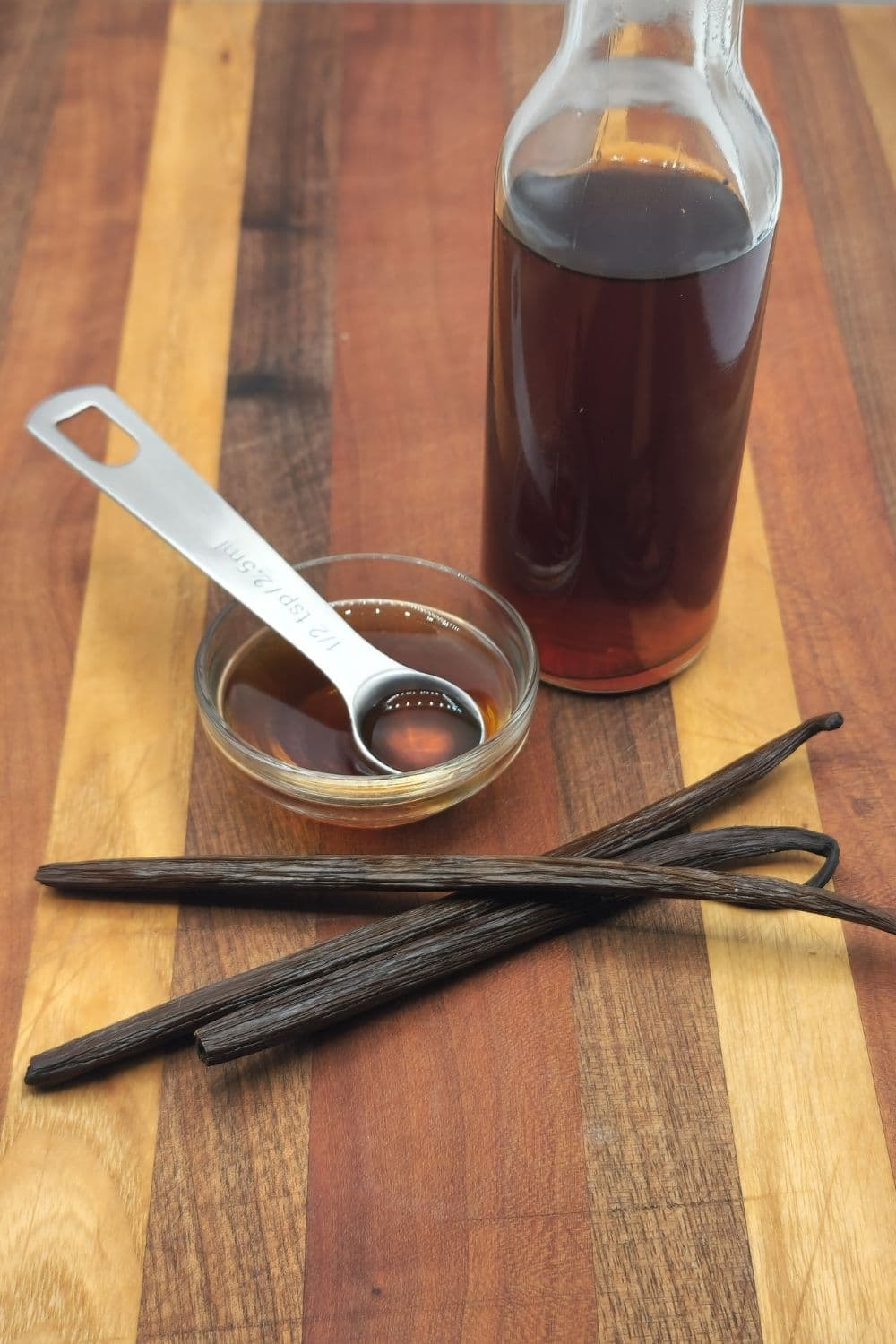Vanilla extract in a small bowl with a measuring spoon