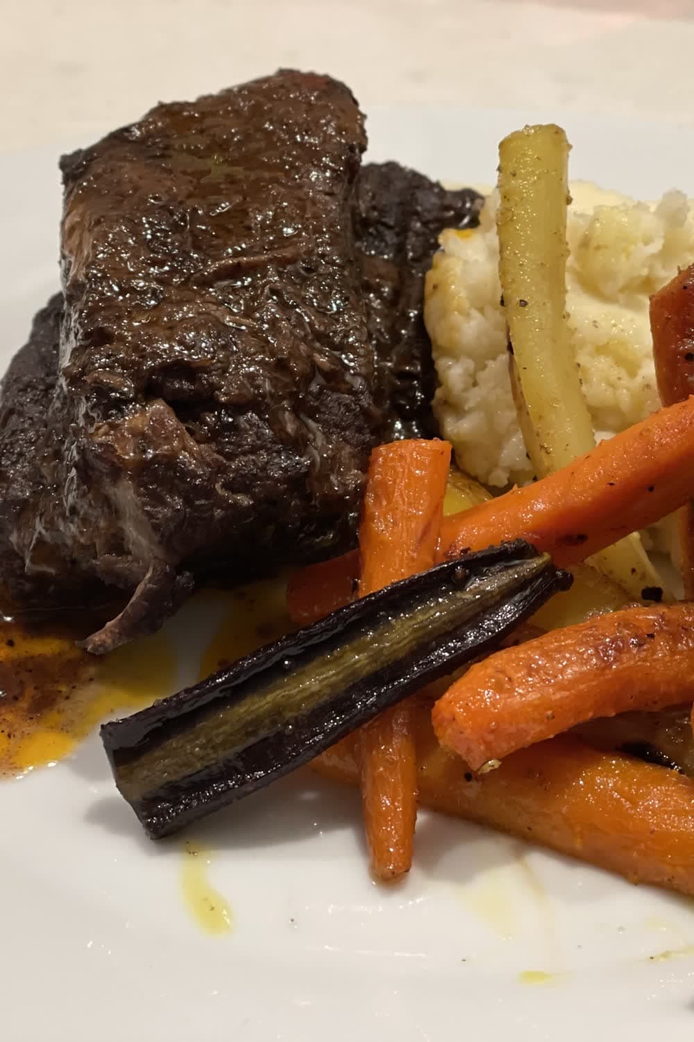 Braised short ribs served over creamy mashed potatoes with reduced sauce