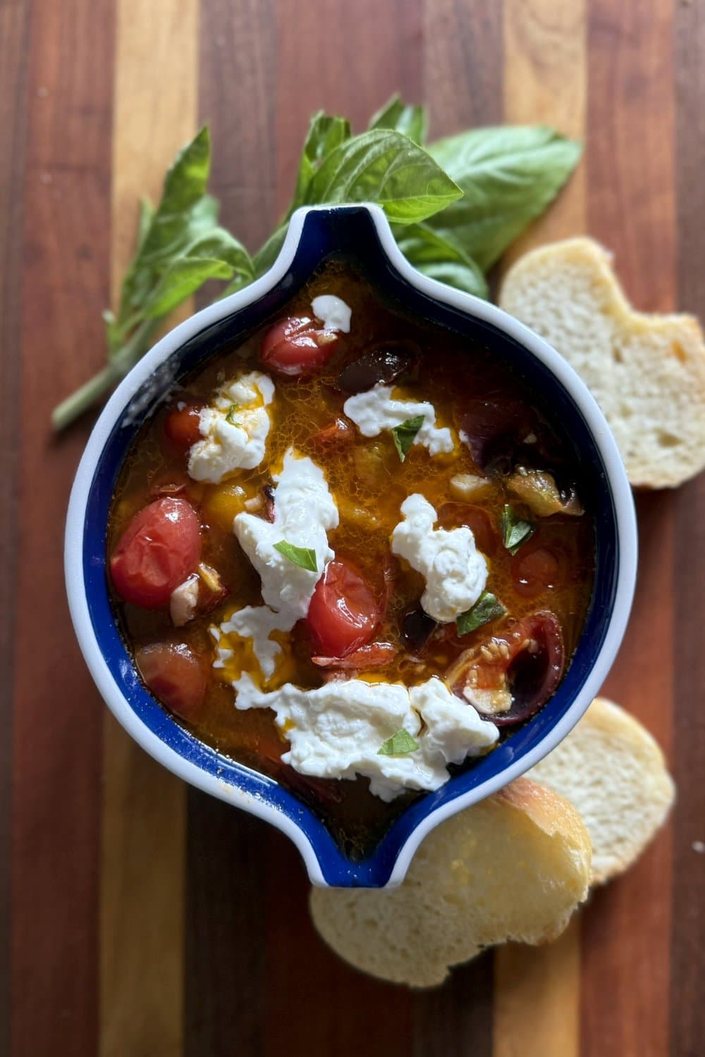 Roasted cherry tomato and burrata dip with crusty bread for serving